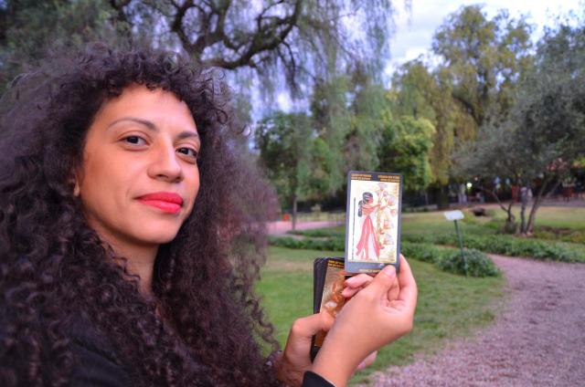 Person holding a card of number 13 from the tarot
